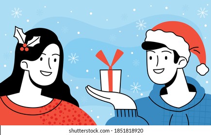 Guy in a santa hat gives girl with a mistletoe in her hair a Christmas present on the background of falling snowflakes. Traditional Christmas exchange of gifts
