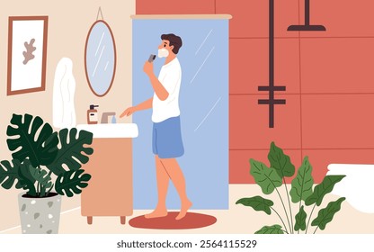 Guy shaves. Daily hygiene procedure. Male facial skin care. Man in bathroom by mirror. Removing bristle process. Everyday routine. Home restroom. Razor and foam. Garish