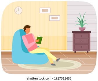 Guy sits at home and reads. Man with book in his hands spending time in apartment. Male character is reading and resting. Person sits in bag chair and studies book. Leisure, pastime at home