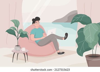 The guy is sitting in a beanbag chair and working on a laptop by the window overlooking the sea and mountains. Concept of home office, remote work, study, online conference. Flat cartoon vector.