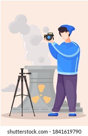 Guy standing and adjusting the lens. Photographic art. A cameraman prepares camera for a photo shoot. Photographer with camera takes picture of the radioactive plant. Factories pollute the environment