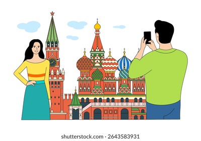 A guy takes a photo of a girl against the backdrop of the Kremlin and St. Basil's Cathedral in Moscow.