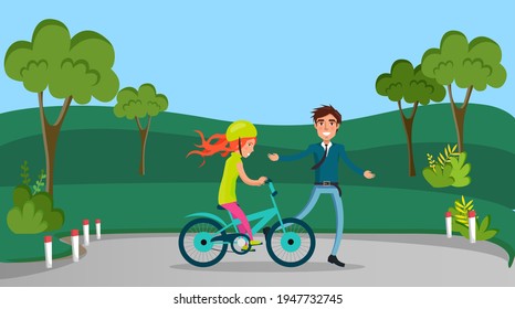 Guy teaches his friend, girl in helmet to ride bike. Man supporting sportswoman on bicycle