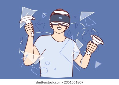 Guy with virtual reality headset on face, holds joysticks for video games and stands among rendered broken glass. Teenager boy uses vr glasses and studies virtual or augmented reality technologies