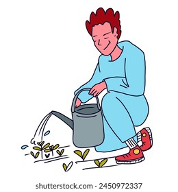 Guy waters spring seedlings in the garden with water from a watering can
