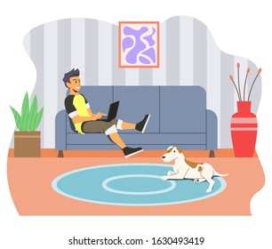 Guy working with his laptop in living room and his dog accompanies him. Suitable for student, internet marketer, freelancer etc.