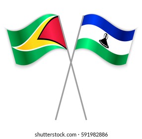Guyanese and Basotho crossed flags. Guyana combined with Lesotho isolated on white. Language learning, international business or travel concept.