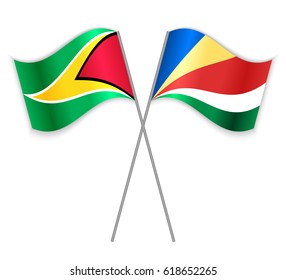 Guyanese and Seychellois crossed flags. Guyana combined with Seychelles isolated on white. Language learning, international business or travel concept.