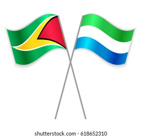 Guyanese and Sierra Leonean crossed flags. Guyana combined with Sierra Leone isolated on white. Language learning, international business or travel concept.