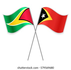 Guyanese and Timorese crossed flags. Guyana combined with East Timor isolated on white. Language learning, international business or travel concept.