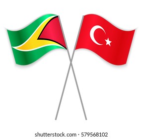Guyanese and Turkish crossed flags. Guyana combined with Turkey isolated on white. Language learning, international business or travel concept.