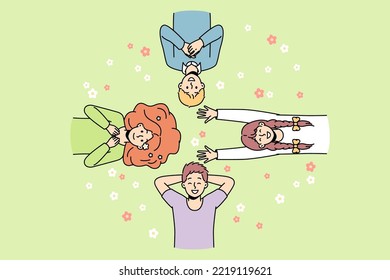 Guys, girls lie on grass among flowers in different directions, look at sky, laugh. Friends spend time at lawn. Top view. Hello spring, summer concept. Vector colorful outline illustration.