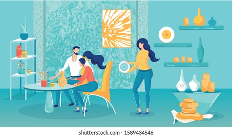 Guys are Painting New Pottery in Cozy Studio. Guy and Girl are Sitting at Table and Decorating Vase. Girl Holds Plate and Shows it. Room has many Shelves with Candles, Banks and Tassels.