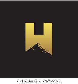H alphabet mountain negative space letter logo gold black background