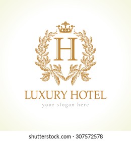 H company logotype. Luxurious hotel. Coat of arms, gold colored royalty heraldry. Decorative creative sign branch of grapes and crown. Isolated abstract graphic design template. Brand identity concept