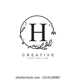 H letter logo design with floral frame ornaments and circular leaves. the letter H design is beautiful and luxurious. H monogram typography. suitable for beauty, business, company, promotion logo etc