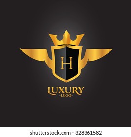 H Letter Luxury Golden Crest logo with wings and crown isolated in black background 