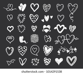 habd drawn doodle hearts set on a blackboard background.