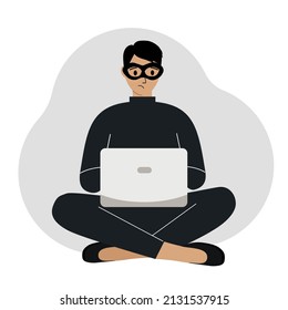 Hacker in a black mask with a computer. The cybercriminal is holding a laptop. Cyber attack, mobile phishing, scam.