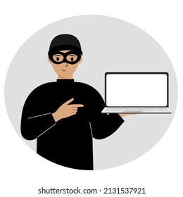 Hacker in a black mask with a computer. The cybercriminal is holding a laptop. Cyber attack, mobile phishing, scam.