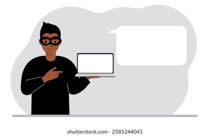 Hacker in a black mask with a computer. The cybercriminal is holding a laptop. Cyber attack, mobile phishing, scam.