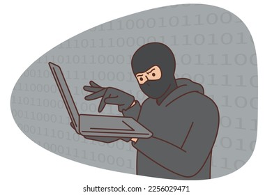 Hacker, cybercriminal with laptop stealing users personal data. Security concept.Hack attacks and web security. A hacker in a black hood with a laptop is trying to carry out a cyber attack.