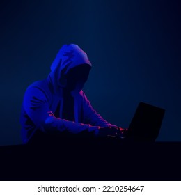 Hacker In Dark. Hooded Figure On Computer. Cyber Security Person. Black Hat Hacking. Neon Light Theme. Vector Illustration.