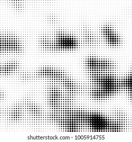 Halftone black and white abstract pattern of dots in black on a white background