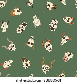 Halloween alive skulls vector seamless pattern. Magical creatures, devils, horned monster's skulls with burning eyes. Hand-drawn repeat on green background for fabric, wallpapers, wrapping paper.