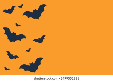 Halloween background with flying bats with copy space on orange background. Design template  for party invitation, decoration, greeting cards, and festive event promotions.