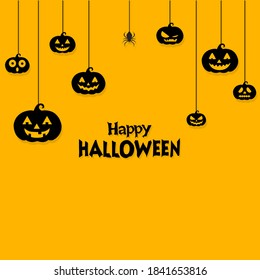Halloween background with hanging  pumpkins and spider on yellow background
