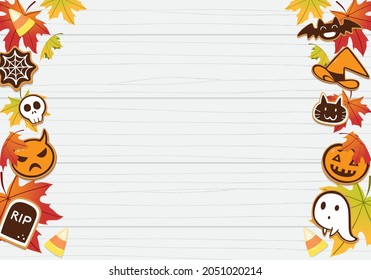 Halloween cookies with maple leaves on wood background.