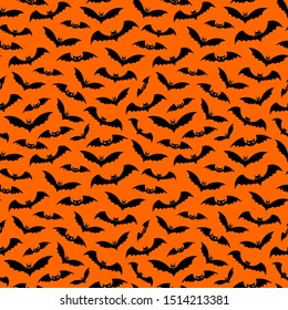 Halloween decorative seamless pattern. Flying bats on orange backdrop. Holiday design for party decorations.