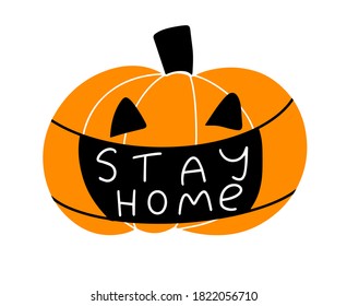halloween during the coronavirus pandemic. lantern pumpkin wearing a protective face mask with the words stay home.