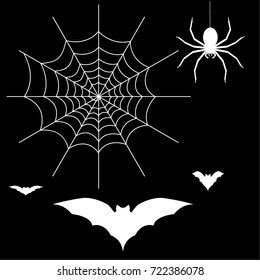 Halloween elements. Spiderweb, bats, and a spider isolated on black