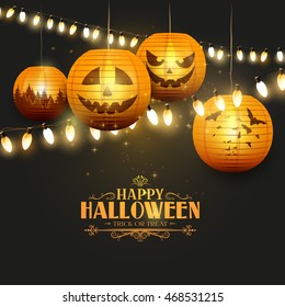 Halloween greeting card with orange paper lanterns and lights on dark background