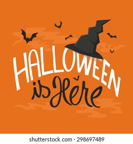 Halloween is here card with witch hat and bats, lettering design