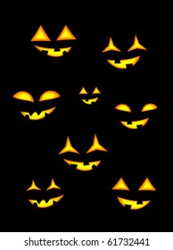 Halloween jack o' lanterns in darkness. Glowing eyes and mouth