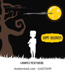 Halloween kid in suit of frankenstein standing on grass