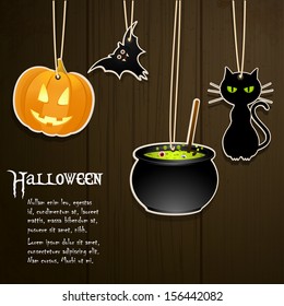 Halloween labels hanging from string against a dark wood background