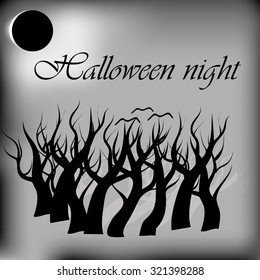 Halloween night background with full moon and dead tree branches.