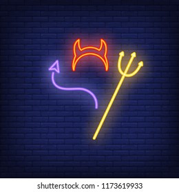 Halloween outfit neon icon. Trident, devil horns and tail on brick wall background. All Hallows eve concept. Vector illustration can be used for street wall signs, party announcements, invitation