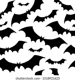 Halloween pattern. Black silhouettes of bats on a white background. Seamless vector backdrop.