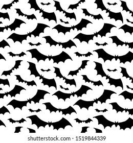 Halloween pattern. Black silhouettes of bats on a white background. Seamless vector backdrop.