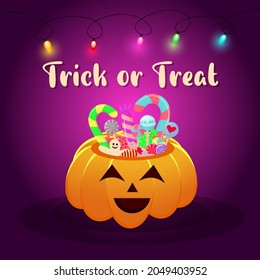 Halloween pumpkin basket full of candies and sweets with garland. Trick or treat lettering.