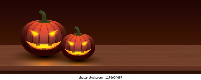 Halloween pumpkin with light glowing in smiling face on wooden table. Use for cover background.