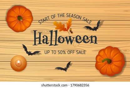 Halloween sale composition. Candle, oak acorn, paper bats and pumpkins on yellow wooden table. Flat lay, top view, copy space. Realistic vector illustration