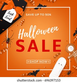 Halloween sale vector background. Top view on spiders, paper bats and confetti on orange backdrop. Vector illustration with black gift box in the form of coffin. Special seasonal offer.