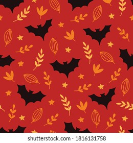 Halloween seamless pattern with bats, leaves, stars on red background. Perfect for wallpaper, gift paper, fabric, holiday decoration, greeting cards