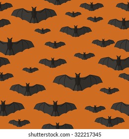 Halloween seamless pattern with bats on orange background.